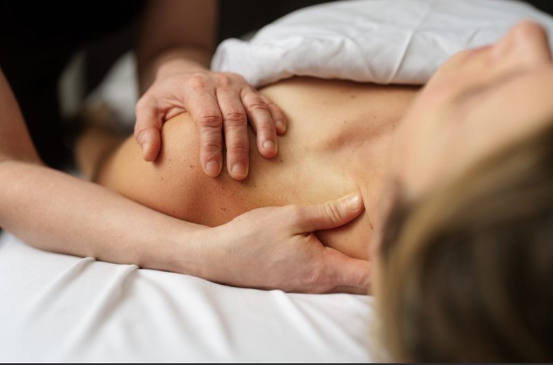 Close-up of hands working along a client's shoulder blade